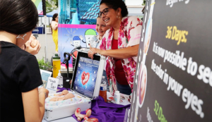 Woman showing fetal development at pro-life display.